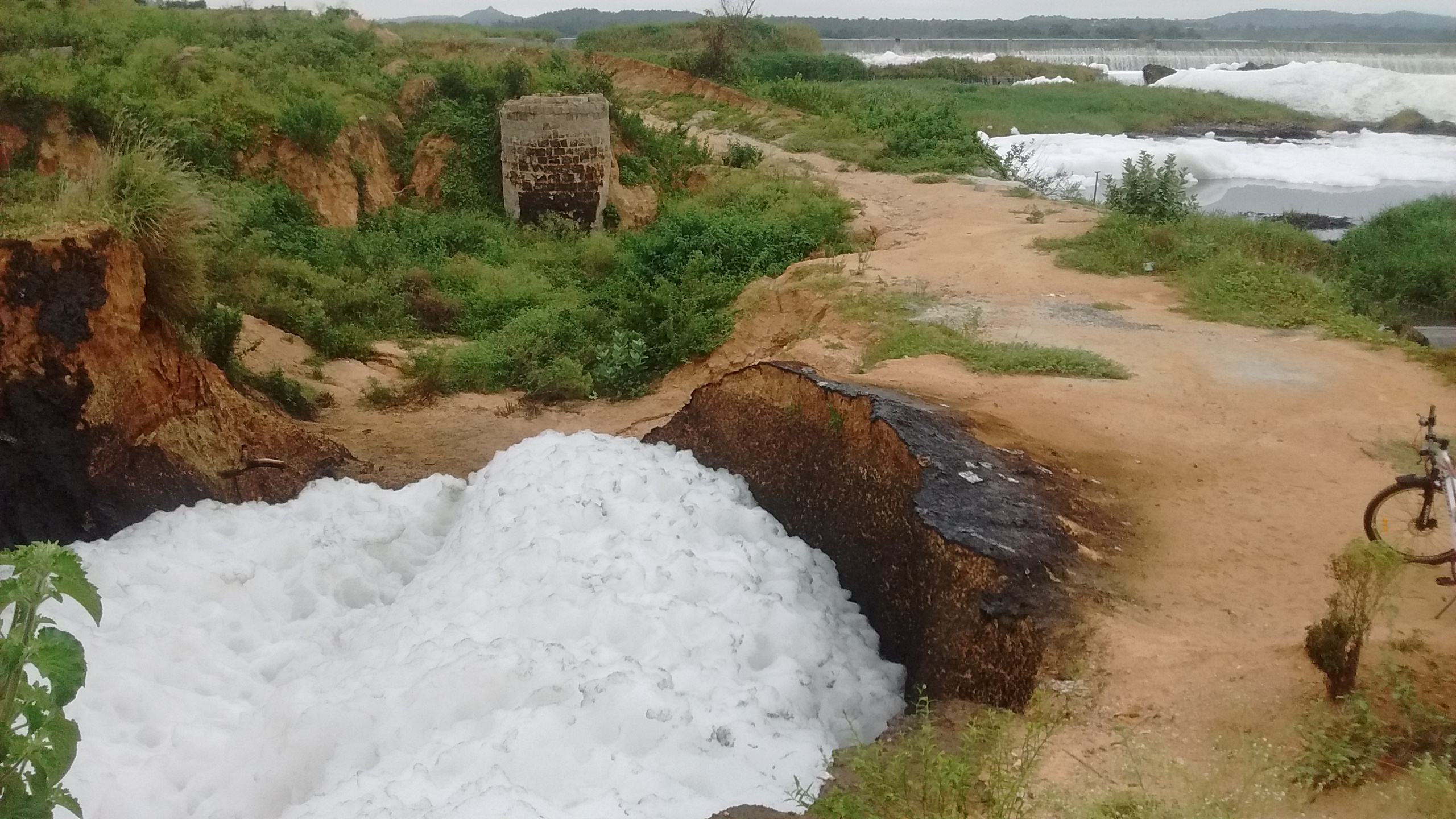 A pit with foam filled in it. As it evaporates it leaves the black chemical deposit